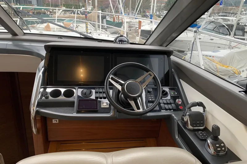 Slide: The Image of Helm of 2019 Princess F49 yacht with modern controls and navigation screens. - 16