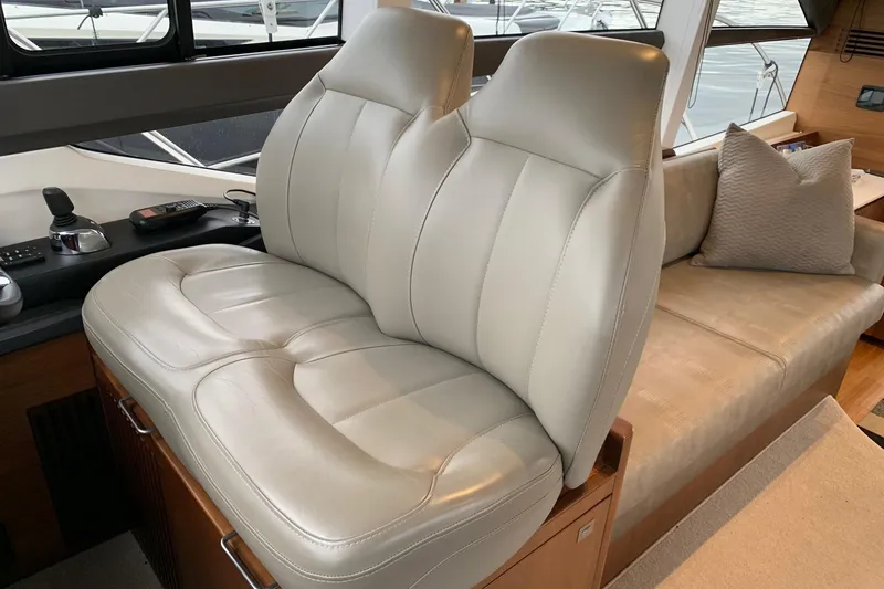 Slide: The Image of Luxurious interior seating of a 2019 Princess F49 yacht, featuring plush leather upholstery. - 19