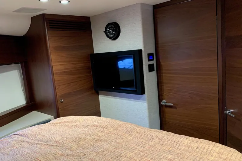 Slide: The Image of Luxurious 2019 Princess F49 yacht interior with wood paneling and mounted TV. - 21