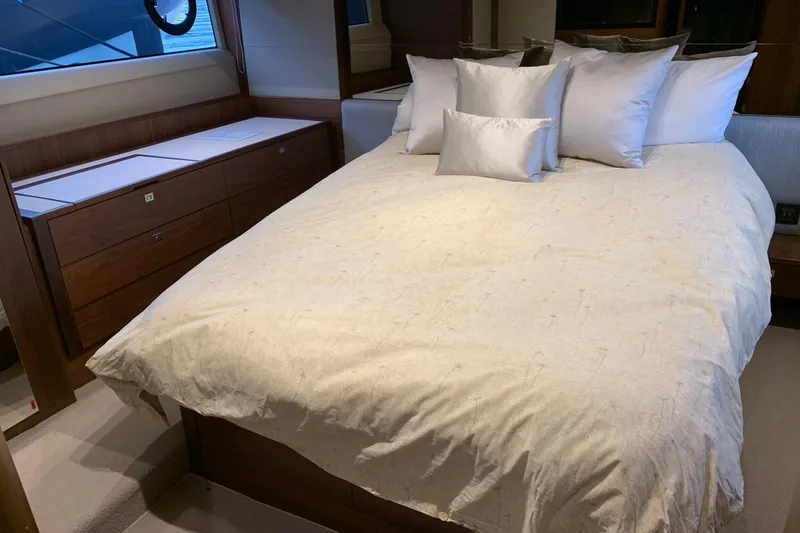 Slide: The Image of Luxurious bedroom interior on a 2019 Princess F49 yacht with plush bedding. - 25
