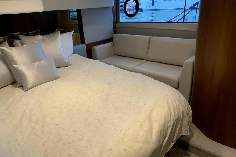 Slide: The Image of Luxurious 2019 Princess F49 yacht bedroom with elegant bedding and a cozy sofa. - 26