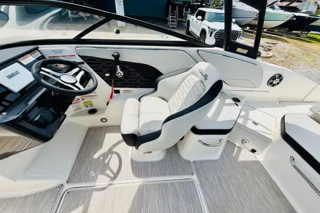 Slide: The Image of 2025 Sea Ray SPX 210 boat interior with modern steering and comfortable seating. - 12