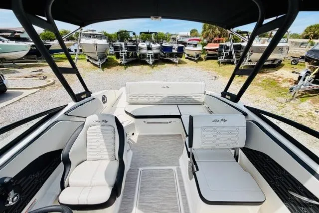 Slide: The Image of 2025 Sea Ray SPX 210 boat interior with sleek seating and modern design. - 17