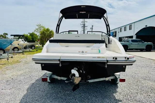 Slide: The Image of 2025 Sea Ray SPX 210 boat on trailer, rear view, parked outdoors. - 3