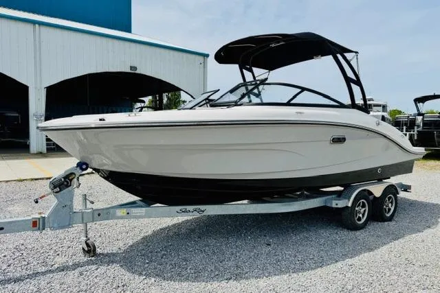 Slide: The Image of 2025 Sea Ray SPX 210 boat on trailer, parked outdoors near a building. - 5