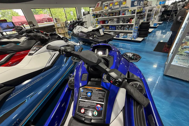 Slide: The Image of 2024 Yamaha WaveRunner GP1800R SVHO in showroom, surrounded by other models and accessories. - 10
