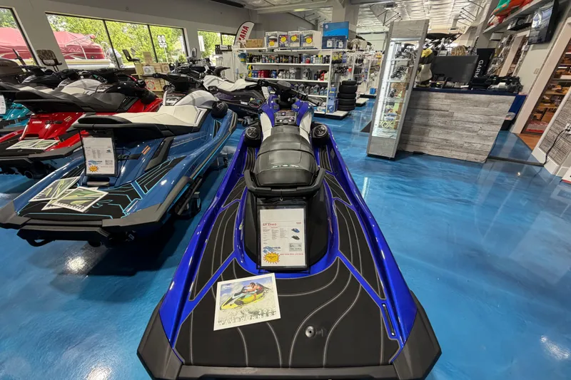 Slide: The Image of 2024 Yamaha WaveRunner GP1800R SVHO in showroom, blue and black design, displayed indoors. - 11