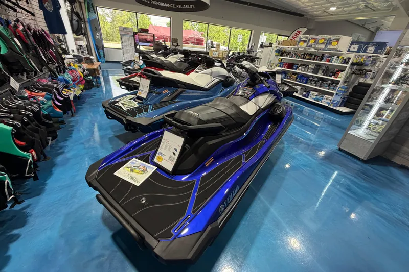 Slide: The Image of 2024 Yamaha WaveRunner GP1800R SVHO in showroom, surrounded by accessories and gear. - 12