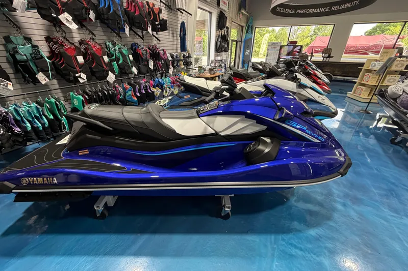 Slide: The Image of 2024 Yamaha WaveRunner GP1800R SVHO in showroom, surrounded by colorful gear. - 8