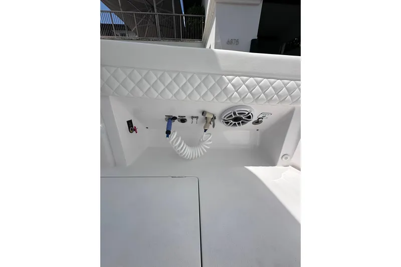 Slide: The Image of 2024 Intrepid 41 Valor boat interior with speaker and hose connections. - 11