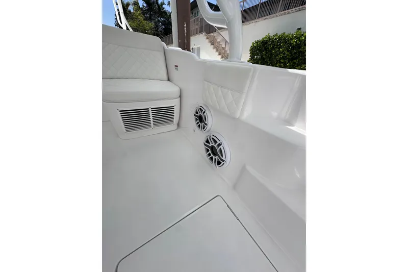 Slide: The Image of 2024 Intrepid 41 Valor boat interior with white seating and built-in speakers. - 12