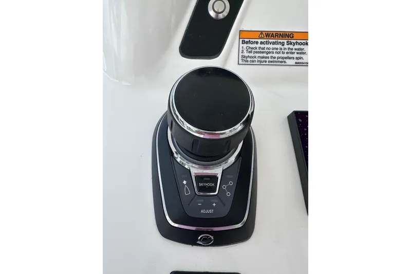 Slide: The Image of Control panel of 2024 Intrepid 41 Valor boat with Skyhook feature and warning label. - 15