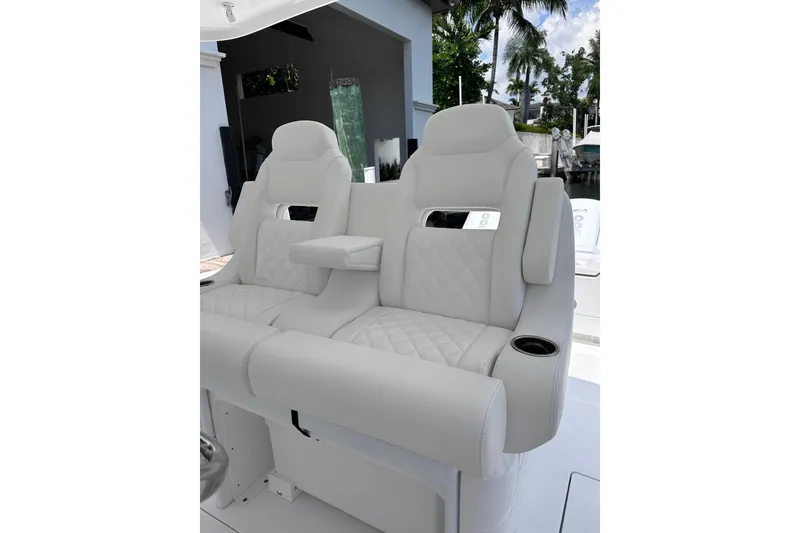 Slide: The Image of Luxurious white seating on 2024 Intrepid 41 Valor boat, featuring quilted design and armrests. - 24