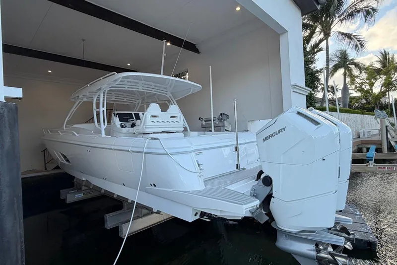 Slide: The Image of 2024 Intrepid 41 Valor boat with Mercury engines in a dockside lift. - 3