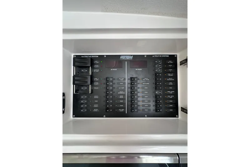 Slide: The Image of Electrical control panel of 2024 Intrepid 41 Valor boat, featuring AC and DC systems. - 34