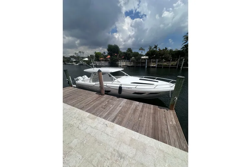 Slide: The Image of 2024 Intrepid 41 Valor boat docked on a sunny day with cloudy skies. - 4