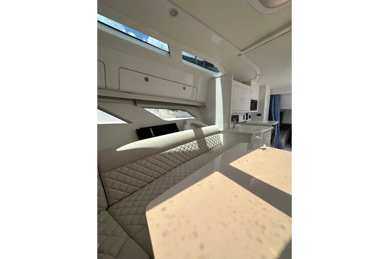 Slide: The Image of Luxurious interior of 2024 Intrepid 41 Valor yacht with modern seating and kitchenette. - 43