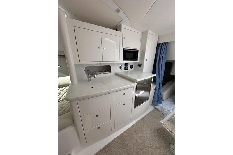 Slide: The Image of 2024 Intrepid 41 Valor yacht interior kitchen with modern cabinetry and appliances. - 45