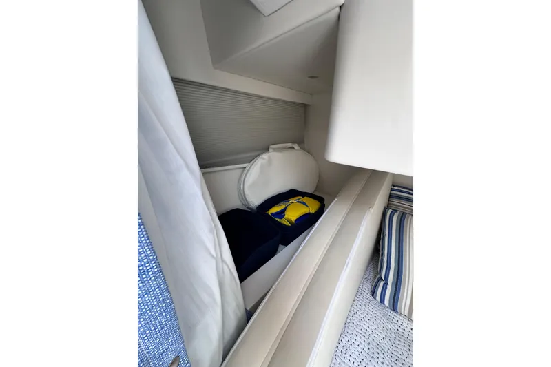 Slide: The Image of 2024 Intrepid 41 Valor cabin storage with cushions and life jackets. - 48
