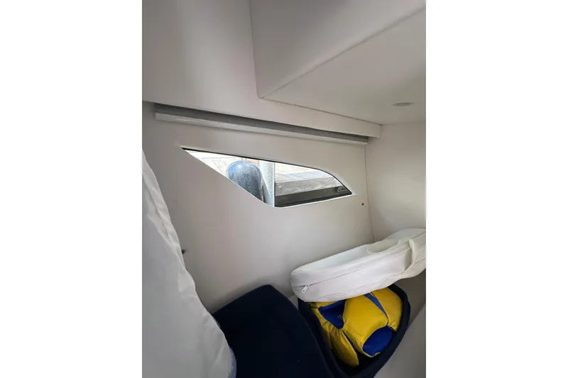 Slide: The Image of Interior cabin view of 2024 Intrepid 41 Valor boat with window and cushions. - 49