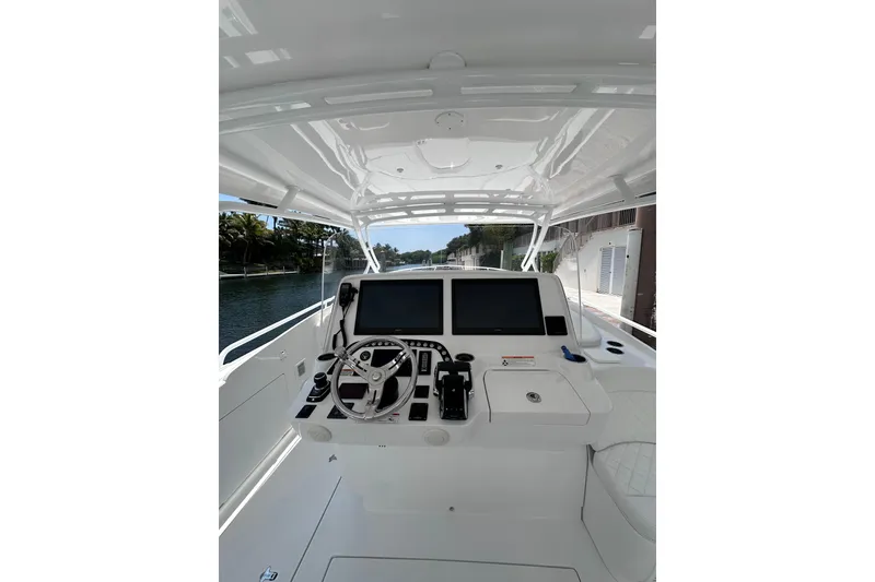 Slide: The Image of 2024 Intrepid 41 Valor boat helm with dual screens and steering wheel. - 5