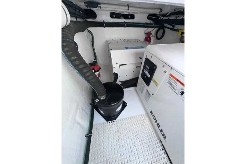 Slide: The Image of Engine room of 2024 Intrepid 41 Valor, featuring Kohler generator and ventilation system. - 53