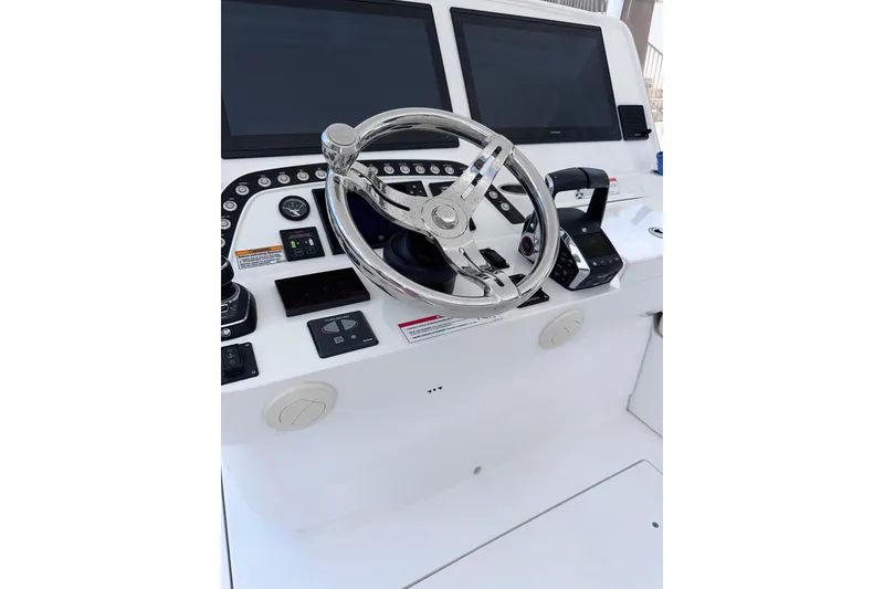 Slide: The Image of 2024 Intrepid 41 Valor helm with dual screens and modern controls. - 57