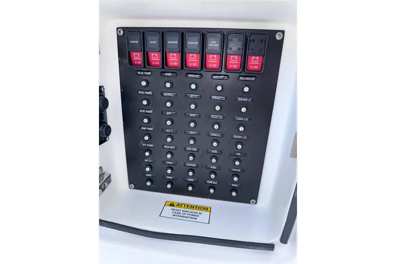 Slide: The Image of Control panel of 2024 Intrepid 41 Valor boat with labeled switches and circuit breakers. - 58