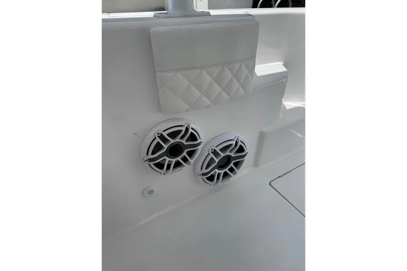 Slide: The Image of 2024 Intrepid 41 Valor boat interior with dual speakers and quilted upholstery detail. - 60