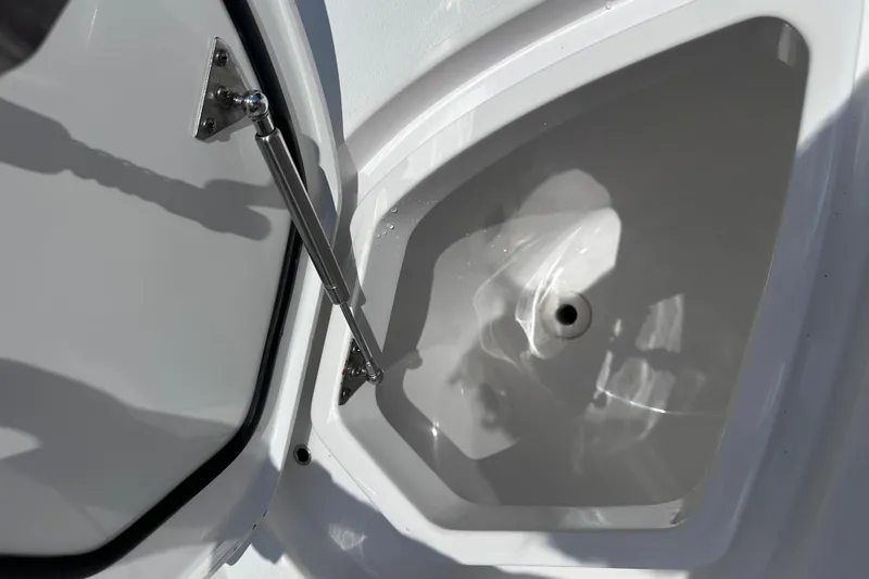 Slide: The Image of Open storage compartment on 2024 Intrepid 41 Valor boat, featuring hydraulic support. - 62