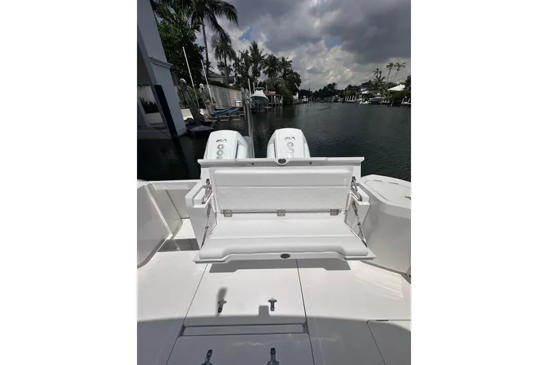 Slide: The Image of 2024 Intrepid 41 Valor boat with dual engines, docked on a serene waterway. - 7