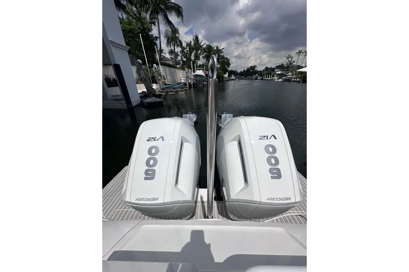 Slide: The Image of Twin Mercury 600 V12 engines on a 2024 Intrepid 41 Valor boat, docked by a canal. - 8