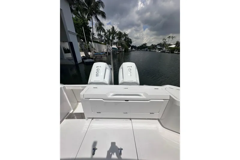 Slide: The Image of 2024 Intrepid 41 Valor boat with dual engines on a calm waterway. - 9