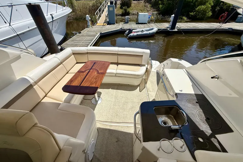 Slide: The Image of Luxurious 2012 Sea Ray 410 Sundancer yacht with spacious seating and outdoor kitchenette. - 12