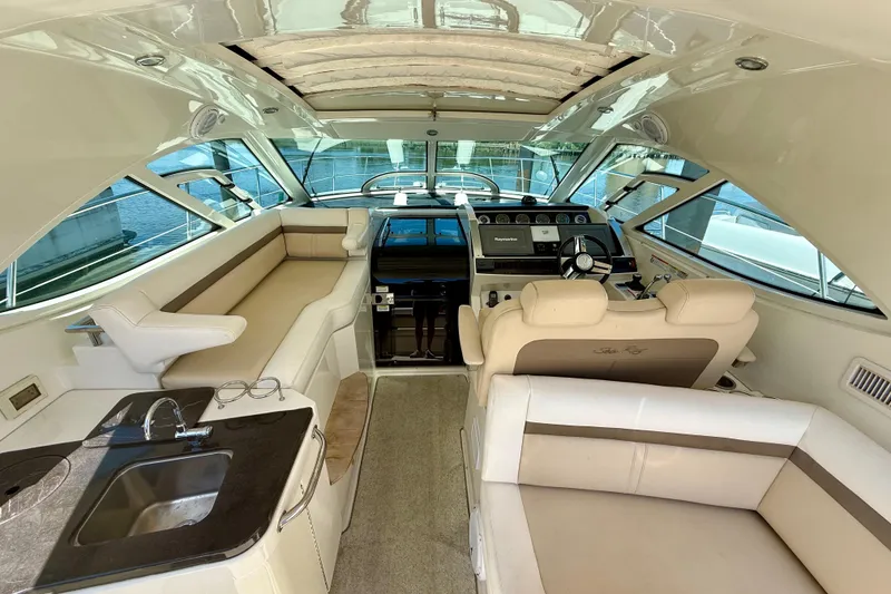 Slide: The Image of Luxurious interior of 2012 Sea Ray 410 Sundancer yacht with helm and seating area. - 13