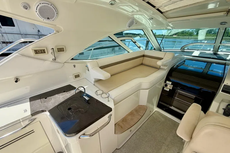 Slide: The Image of Luxurious interior of 2012 Sea Ray 410 Sundancer yacht with seating and kitchenette. - 14