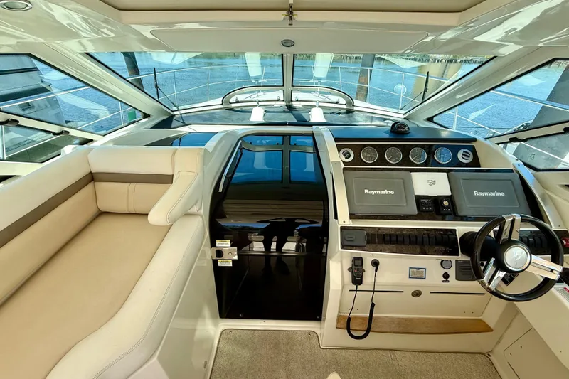 Slide: The Image of Luxurious helm of 2012 Sea Ray 410 Sundancer with modern navigation equipment. - 15