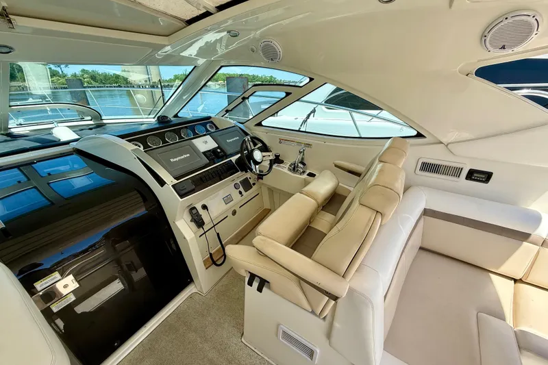 Slide: The Image of Luxurious interior of 2012 Sea Ray 410 Sundancer yacht with modern helm and seating. - 16