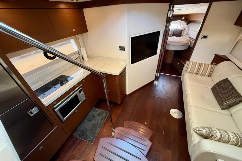 Slide: The Image of Luxurious interior of 2012 Sea Ray 410 Sundancer yacht with modern kitchen and cozy seating. - 19