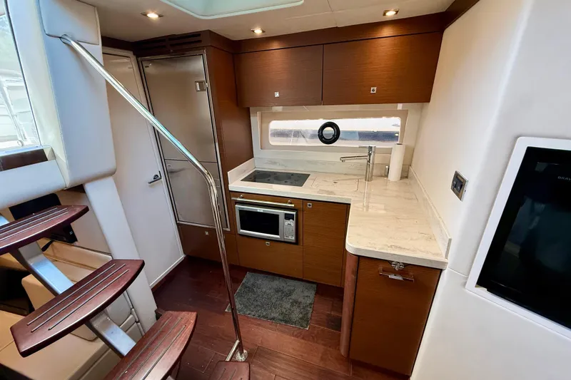 Slide: The Image of Modern kitchen interior of 2012 Sea Ray 410 Sundancer yacht with sleek design. - 22