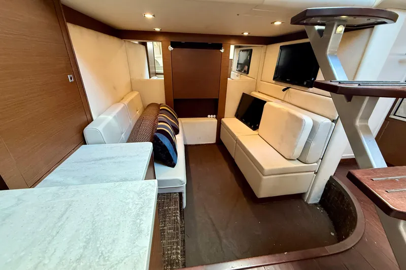 Slide: The Image of Interior of 2012 Sea Ray 410 Sundancer yacht with modern seating and TV. - 24
