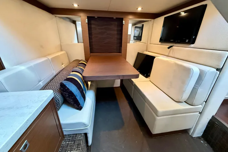 Slide: The Image of Luxurious interior of 2012 Sea Ray 410 Sundancer yacht with cozy seating and table. - 25