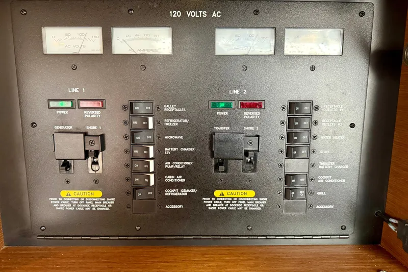 Slide: The Image of Electrical panel of a 2012 Sea Ray 410 Sundancer boat, showing switches and meters. - 31