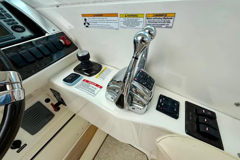 Slide: The Image of Control panel of a 2012 Sea Ray 410 Sundancer boat with throttle and joystick. - 33