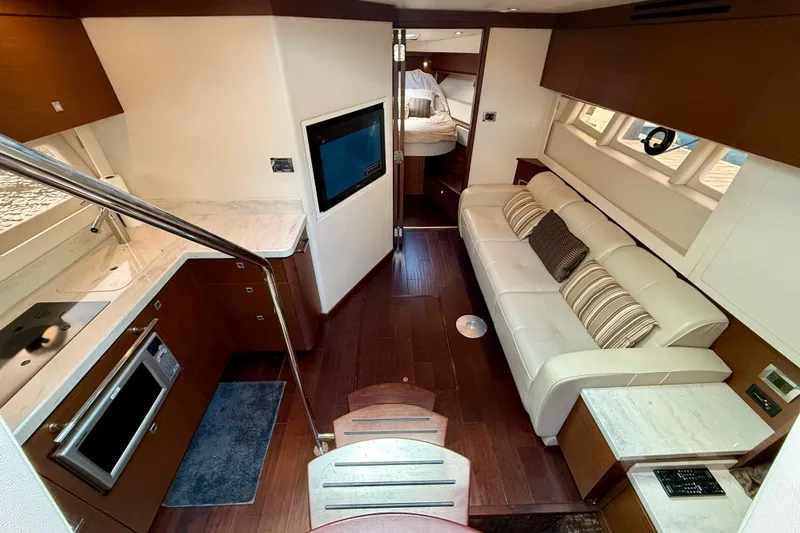 Slide: The Image of Luxurious interior of 2012 Sea Ray 410 Sundancer yacht with modern kitchen and cozy seating. - 34