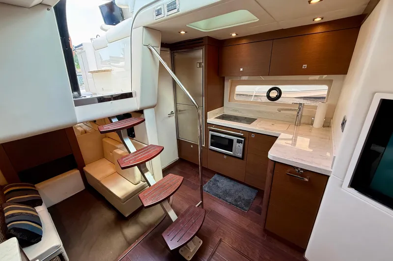 Slide: The Image of Luxurious interior of 2012 Sea Ray 410 Sundancer yacht with modern kitchen and seating area. - 35