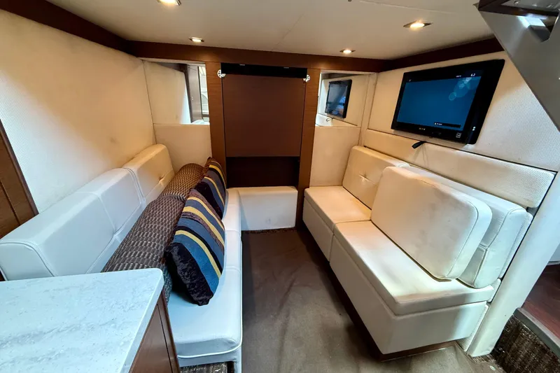 Slide: The Image of Luxurious interior of 2012 Sea Ray 410 Sundancer yacht with plush seating and TV. - 39