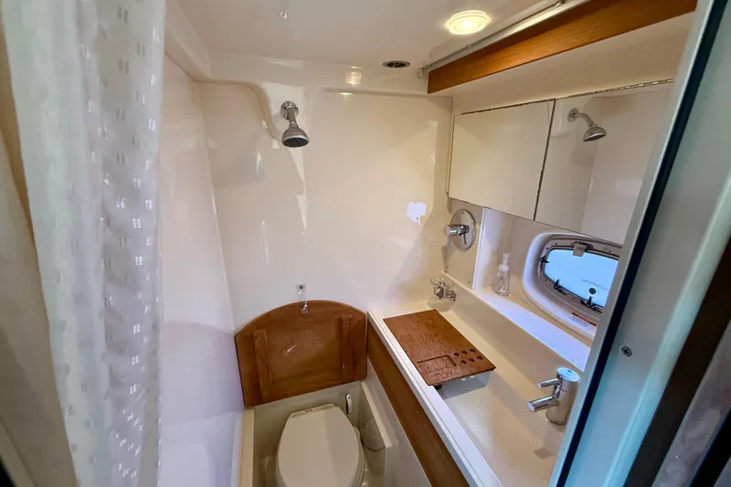 Slide: The Image of Luxurious bathroom in 2012 Sea Ray 410 Sundancer yacht with modern fixtures and wood accents. - 42