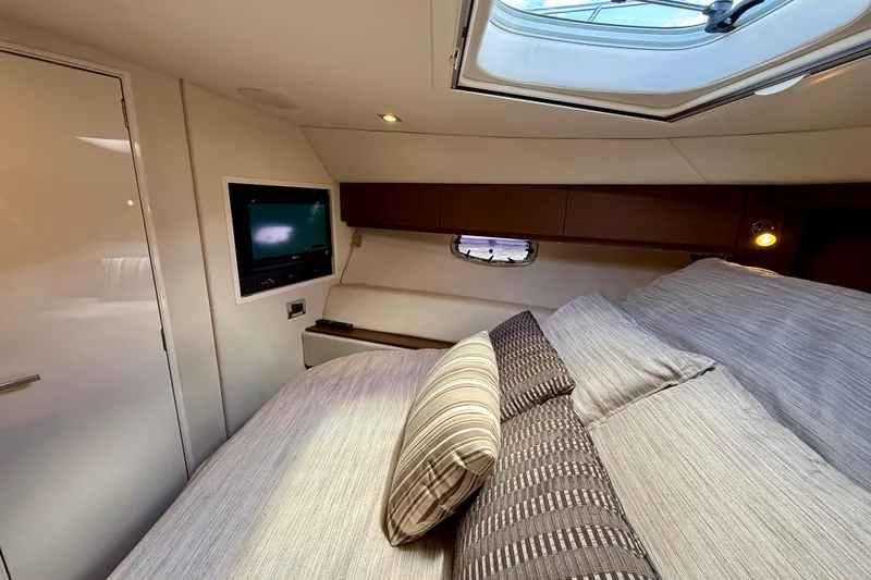 Slide: The Image of Luxurious cabin interior of 2012 Sea Ray 410 Sundancer yacht with skylight and TV. - 46