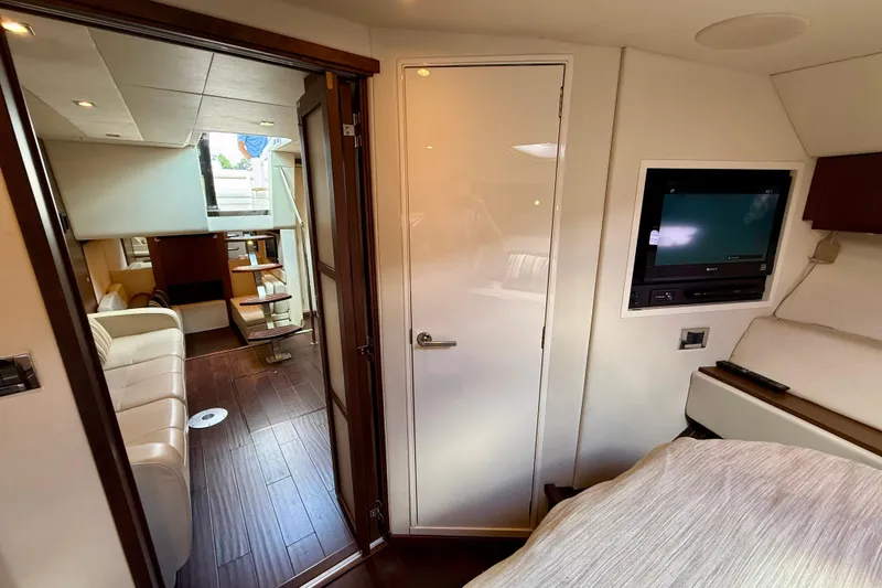 Slide: The Image of Interior of 2012 Sea Ray 410 Sundancer yacht with modern furnishings and TV. - 47